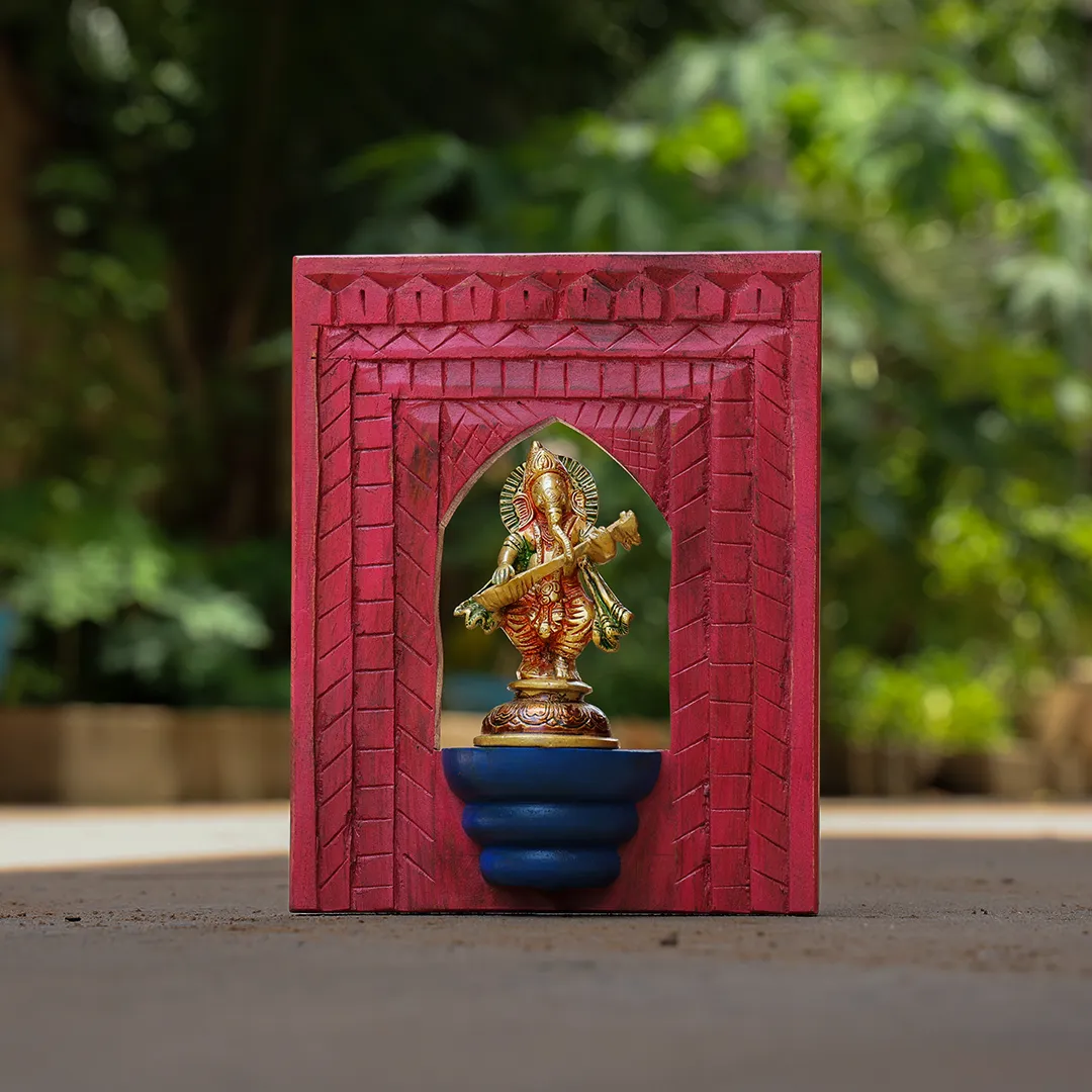 Lord Ganesh playing veena brass idol with distressed wooden frame wall decor